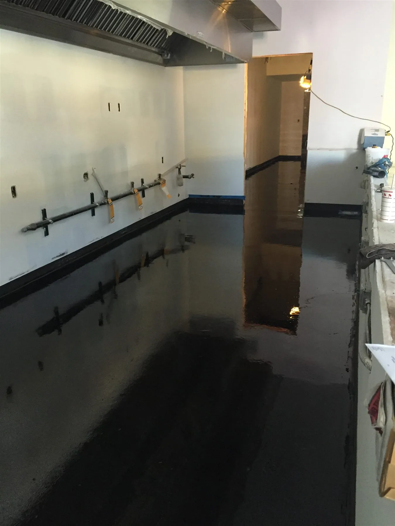 Black epoxy floor in a restaurant kitchen