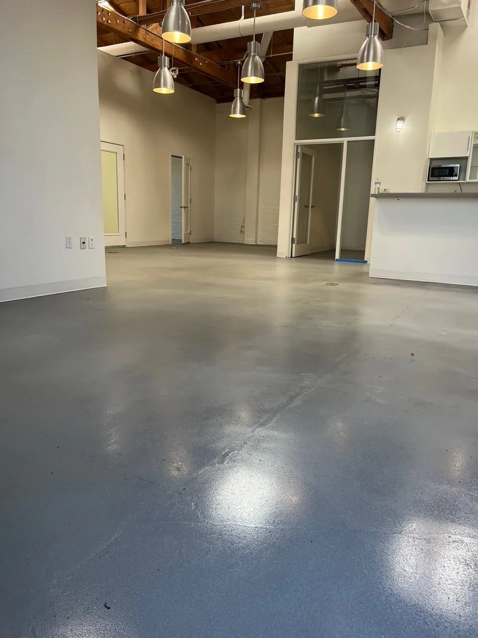 Glossy grey epoxy floor in an open loft