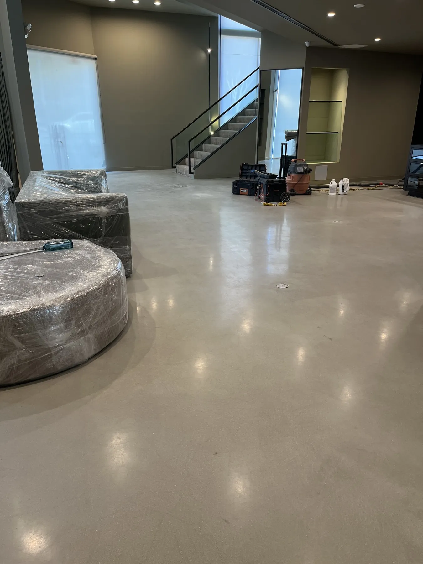 Polished concrete floor in an office lobby with a stairway