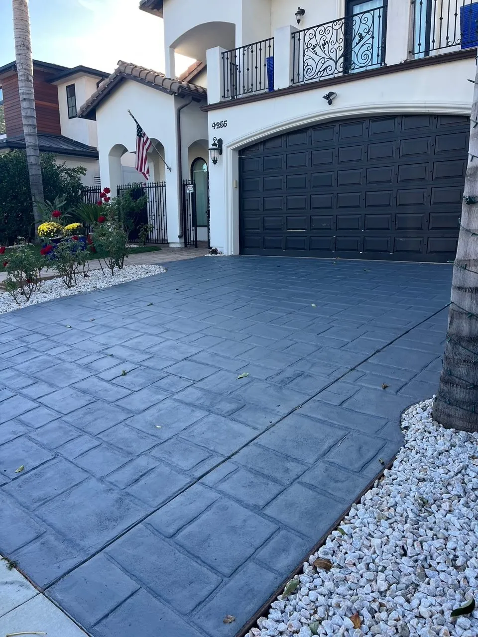 Blue-grey stained concrete driveway at a Spanish-style home